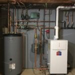 A gas boiler and water heater in a room.